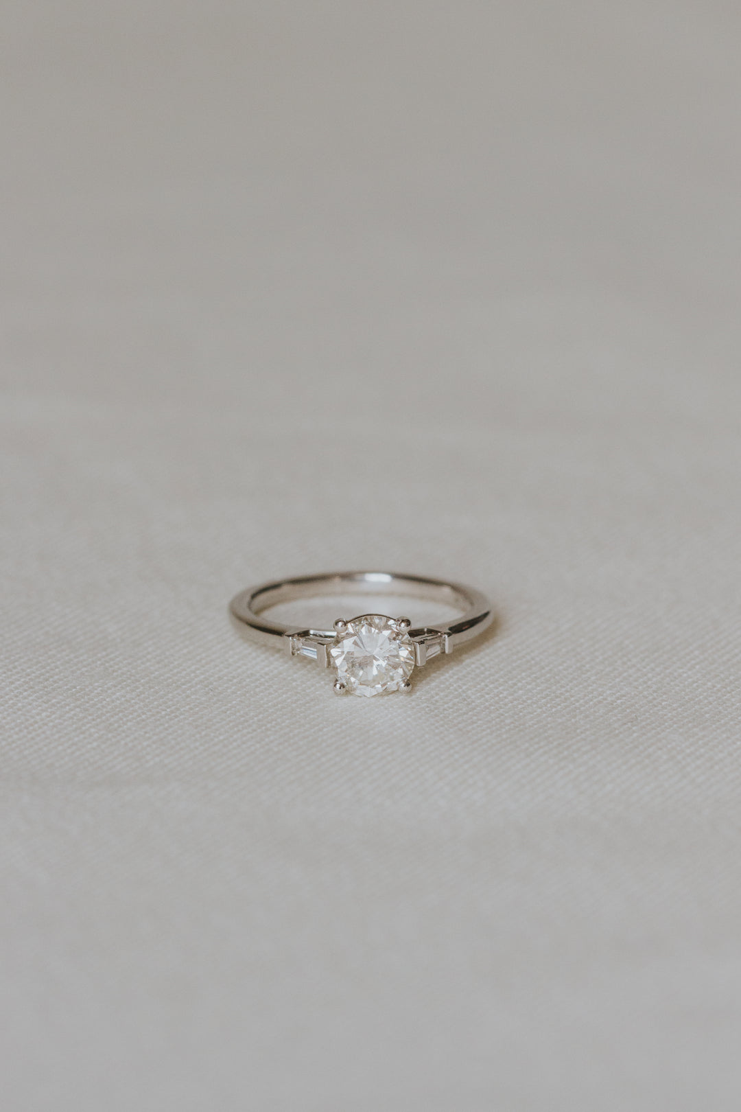 Diamond ring on a light gray fabric background